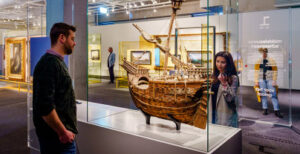 Twee personen bewonderen modelschip in het Maritiem Museum